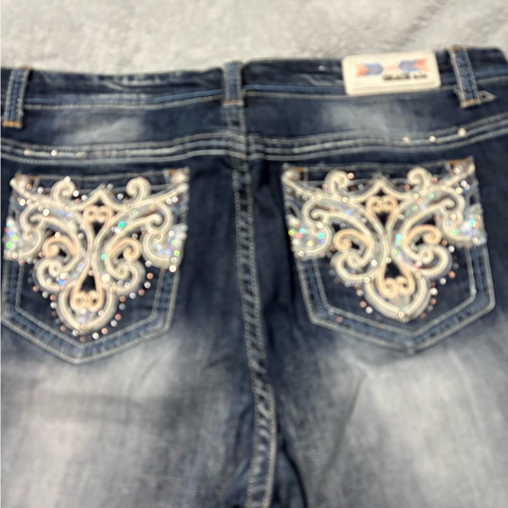 Grace in LA ladies jeans. Has clear rhinestones, sequins & colored thread.
